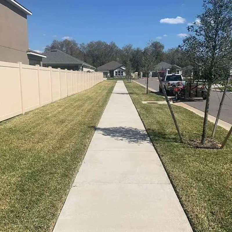 Freshly mowed and edged lawn along a sidewalk in a Valrico, FL neighborhood